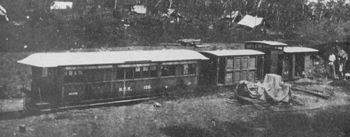 Exterior view of "NBP 4" and a NHS brakevan, circa 1910