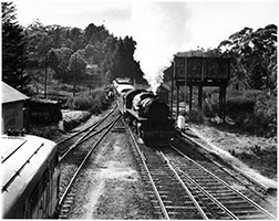 c.1960,loco SAR 701 with an up Bridgewater passenger crossing loco 930 on freight - overhead water tank,Aldgate