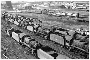 overhead view stored SAR locos - loco 711 + 716 + 719 + 712 + 529 - accident train wagons + others in background - Mile End Loco