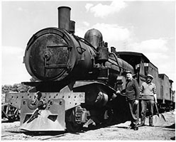 loco SAR T209 being oiled by crew - fireman holding shovel