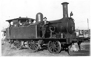 3.1927 - loco SAR P117 - building at rear is booking office Alison Street - Fireman Sam Headsom (acting Fireman) cleaner George Carter (acting fireman)  - engine is shown in Glenelg Loco Shed Yard and has just complete 5 runs on the South terrace line - McDonald - Glenelg Line